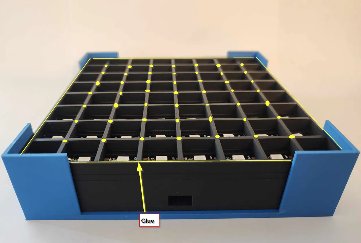 A blue box with black and yellow squaresDescription automatically generated
