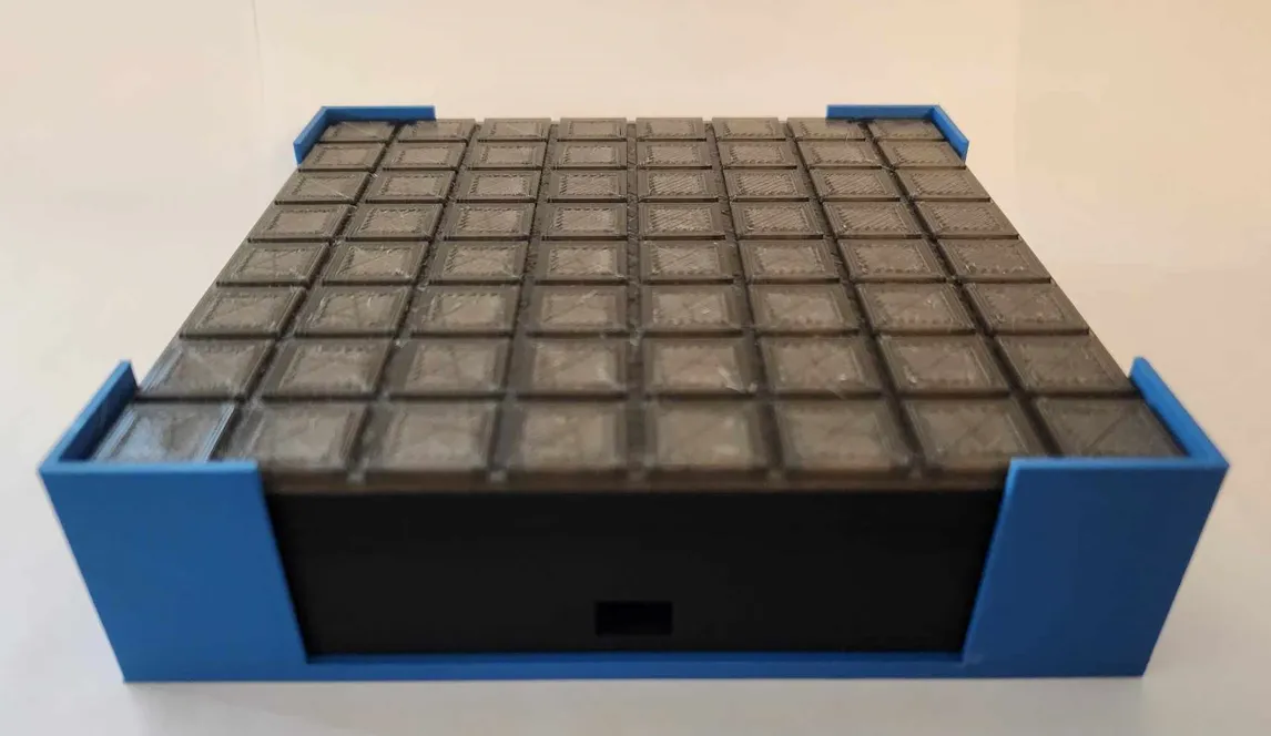 A blue and black box with square squaresDescription automatically generated