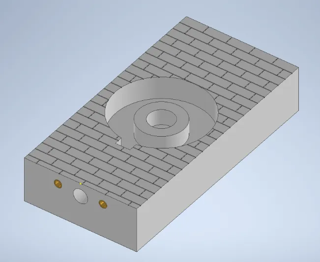 A grey rectangular object with a circular object in the middleDescription automatically generated