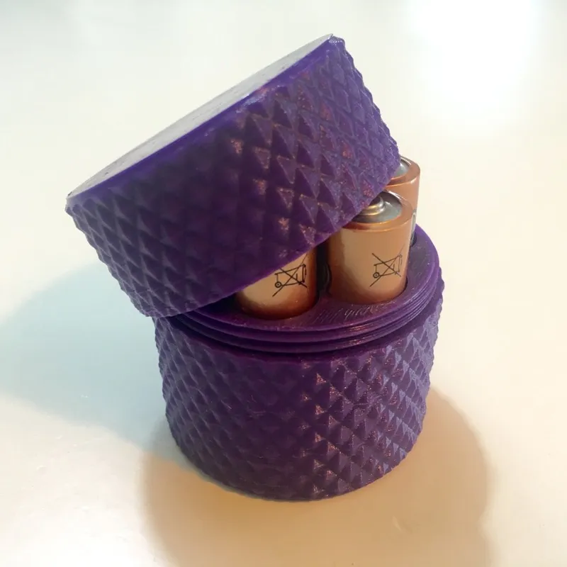 Knurled AA battery container with screw on lid.