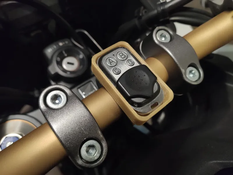 Garage door remote holder for motorcycle handlebars