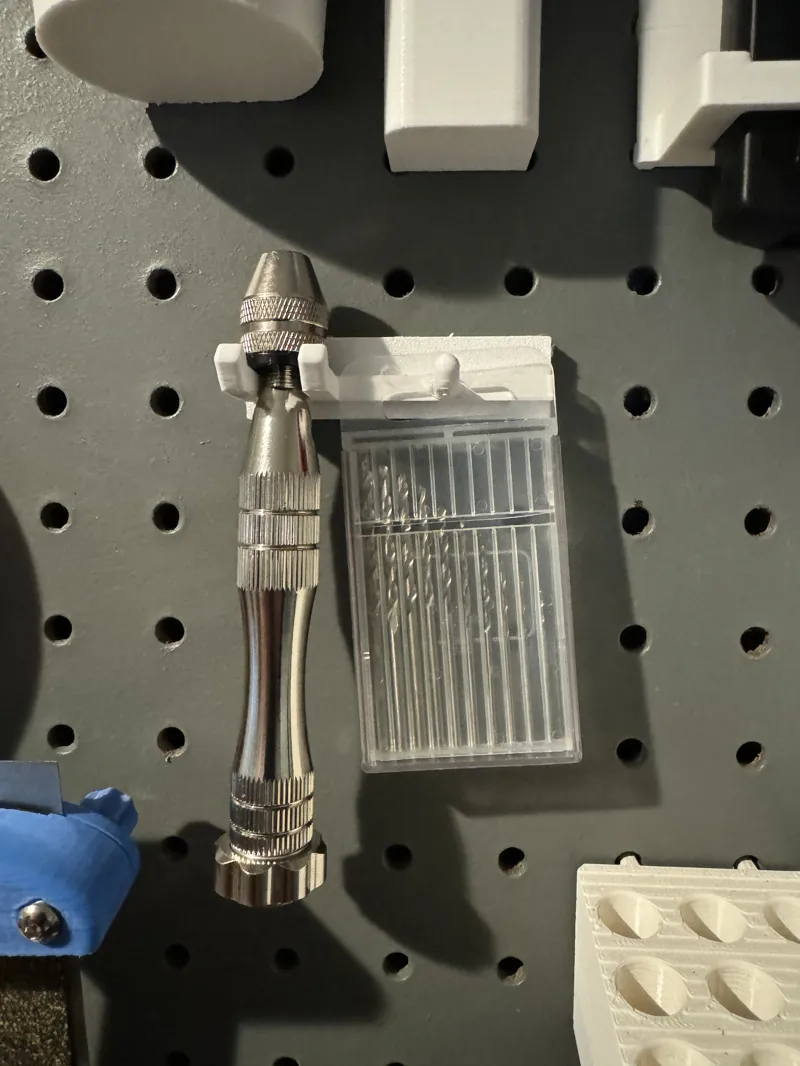 Hand drill arm for pegboard