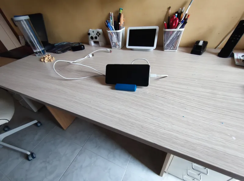 Mobile phone stand with cable and earbuds holder