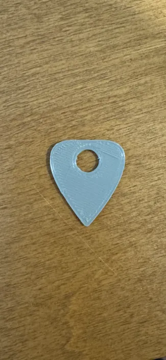 Guitar pick with a cord hole