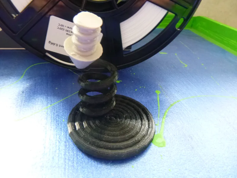 printer nozzle suspended by print
