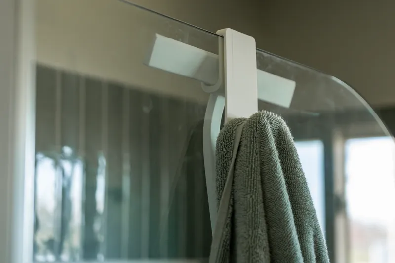 Towel and squeegee hook for shower glass