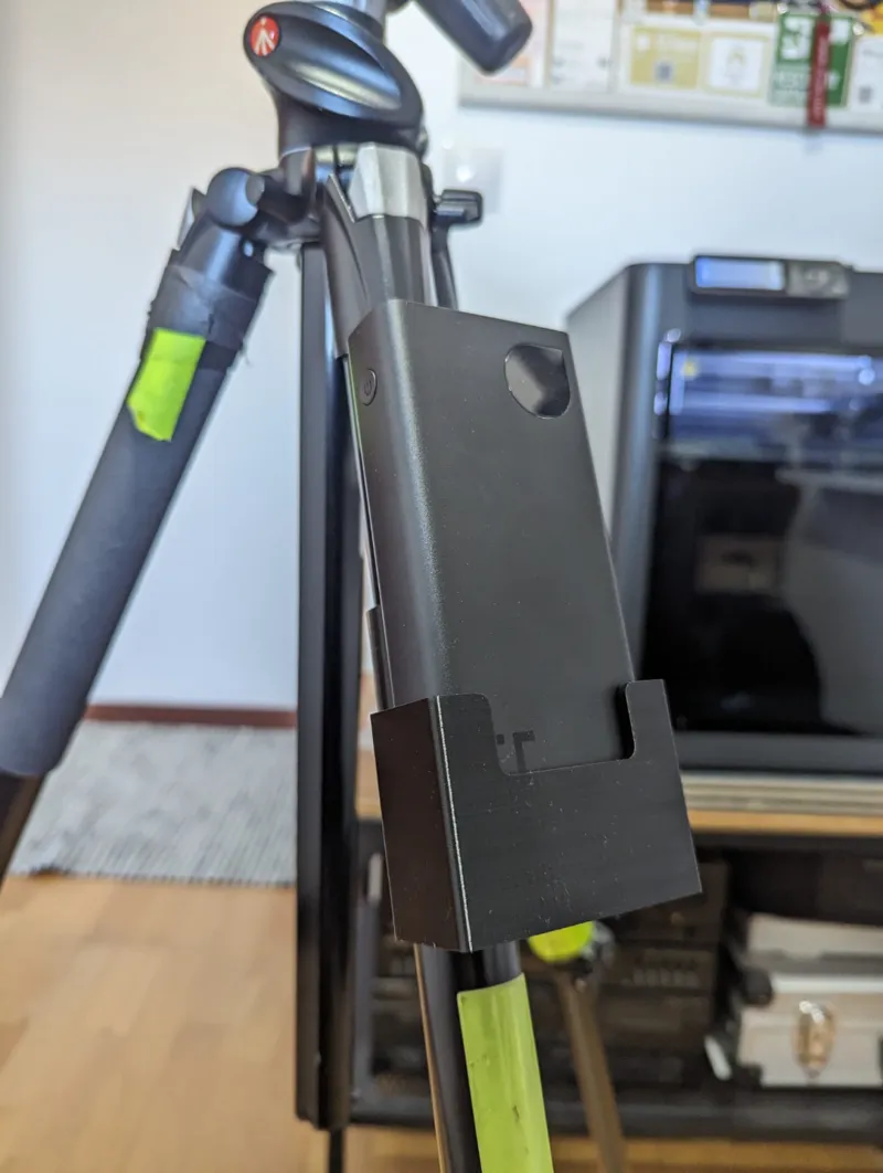 Powerbank holder for tripod leg