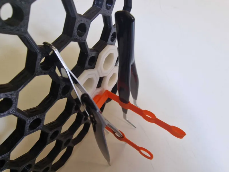 Multiboard tweezer hanger perpendicular spacesaver