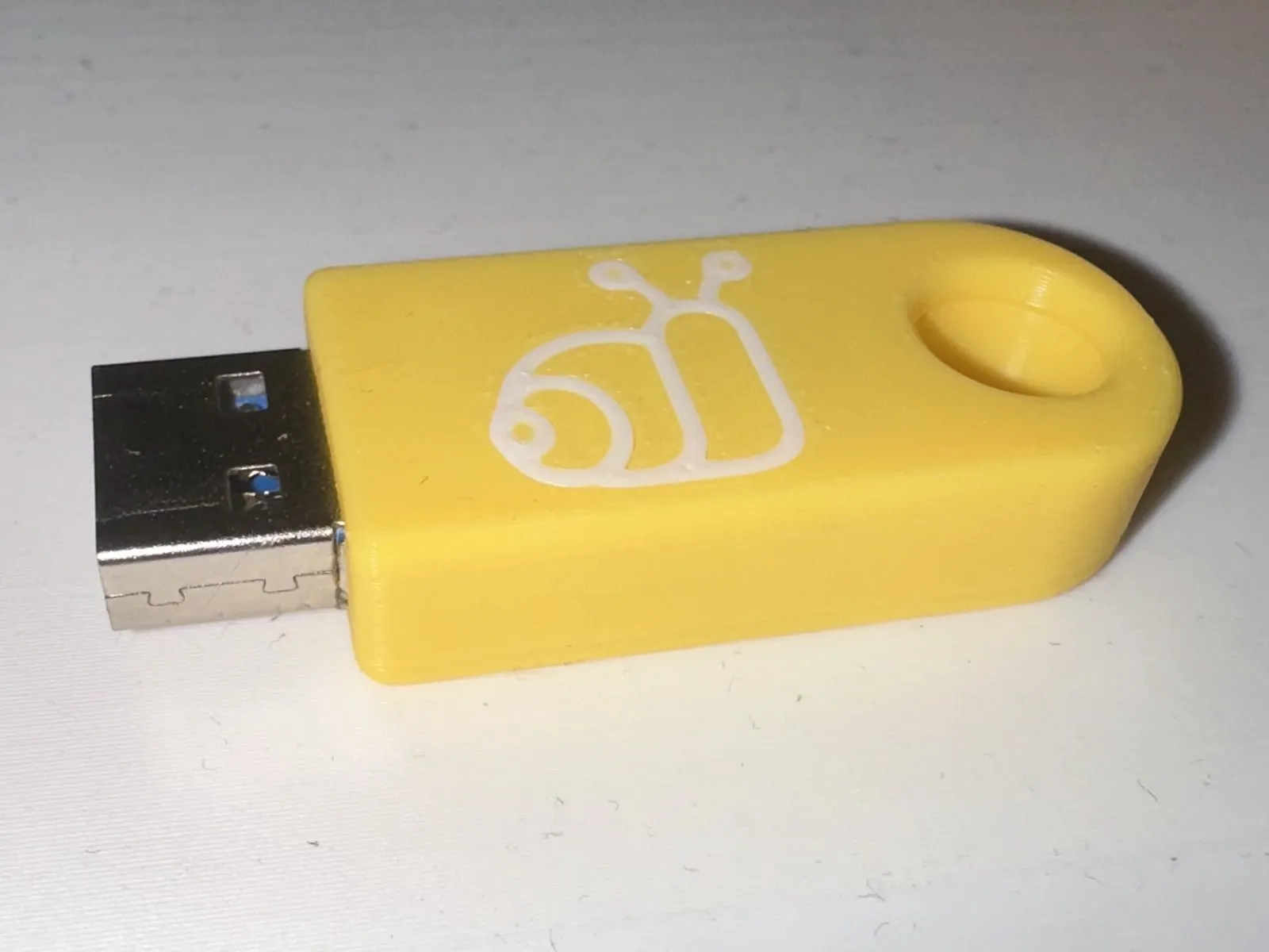 Picture showing the assembled USB thumb drive with the snail logo on top