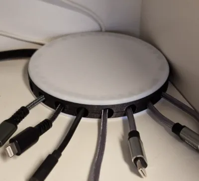 Round cover with organized outlets for cables
