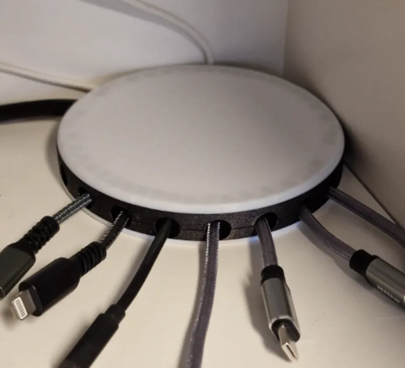 Round cover with organized outlets for cables