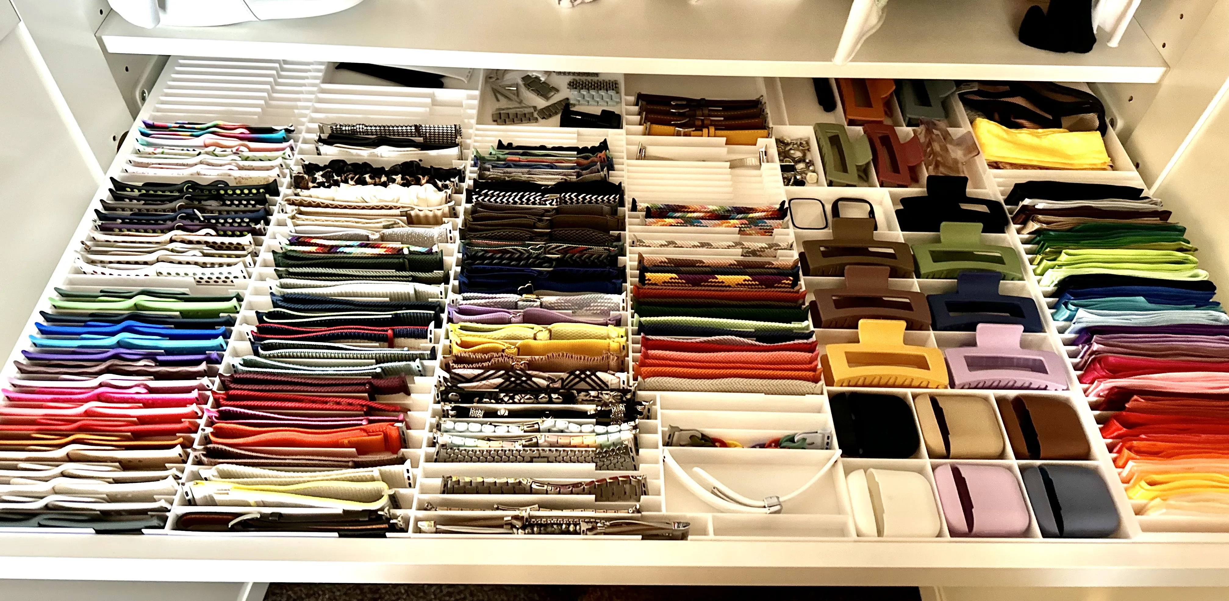 wardrobe drawer with several custom designed compartments to hold and display serveral things