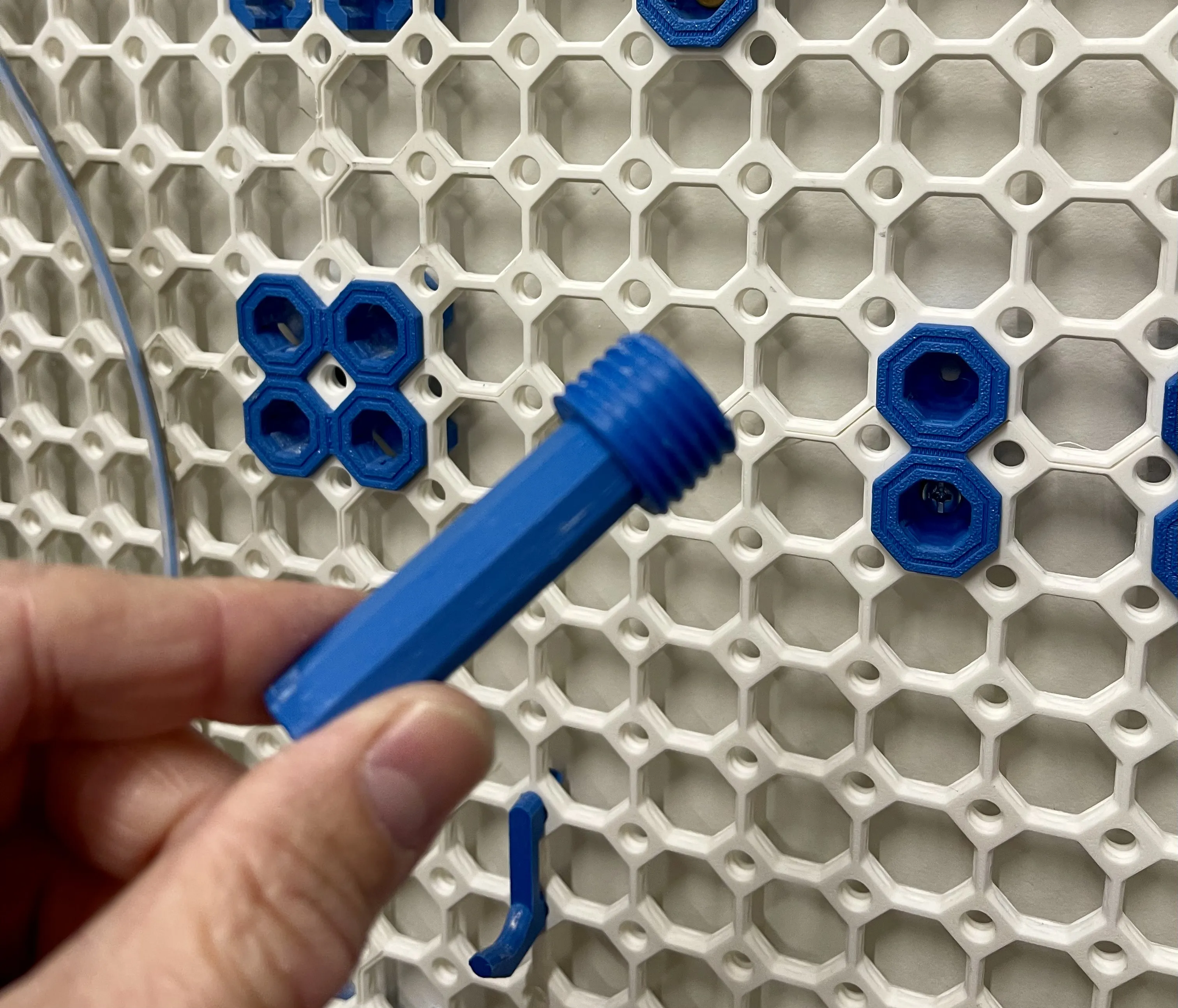 Using a peg to screw the bolt into the tile