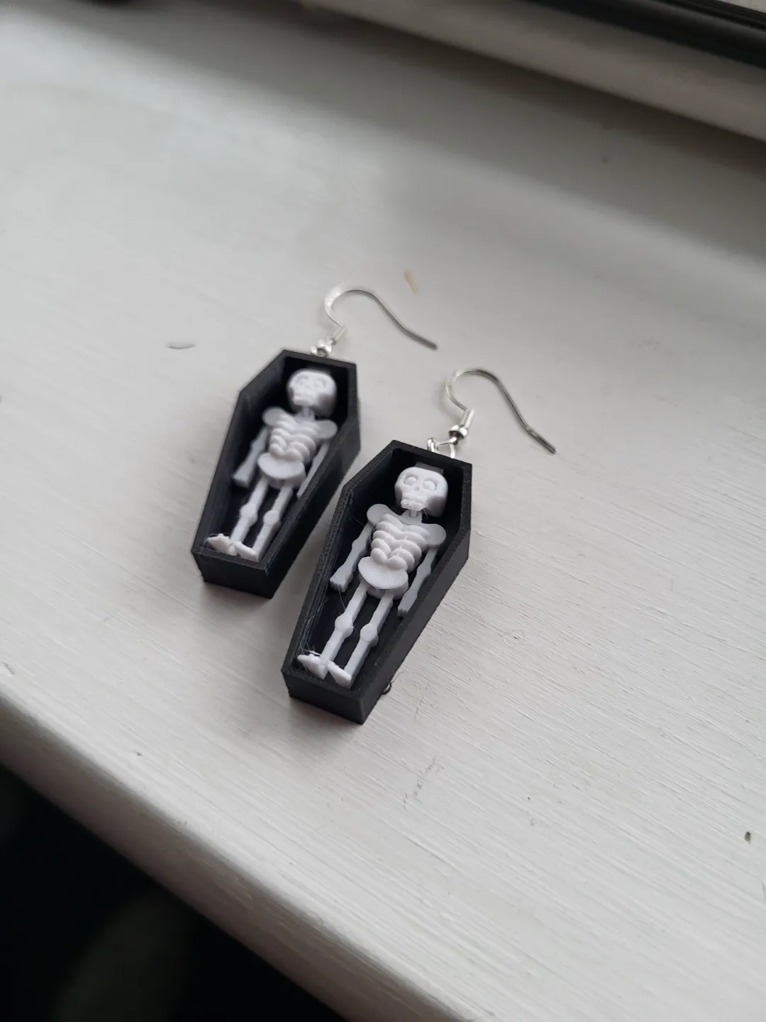 skeleton in coffin earring view 3