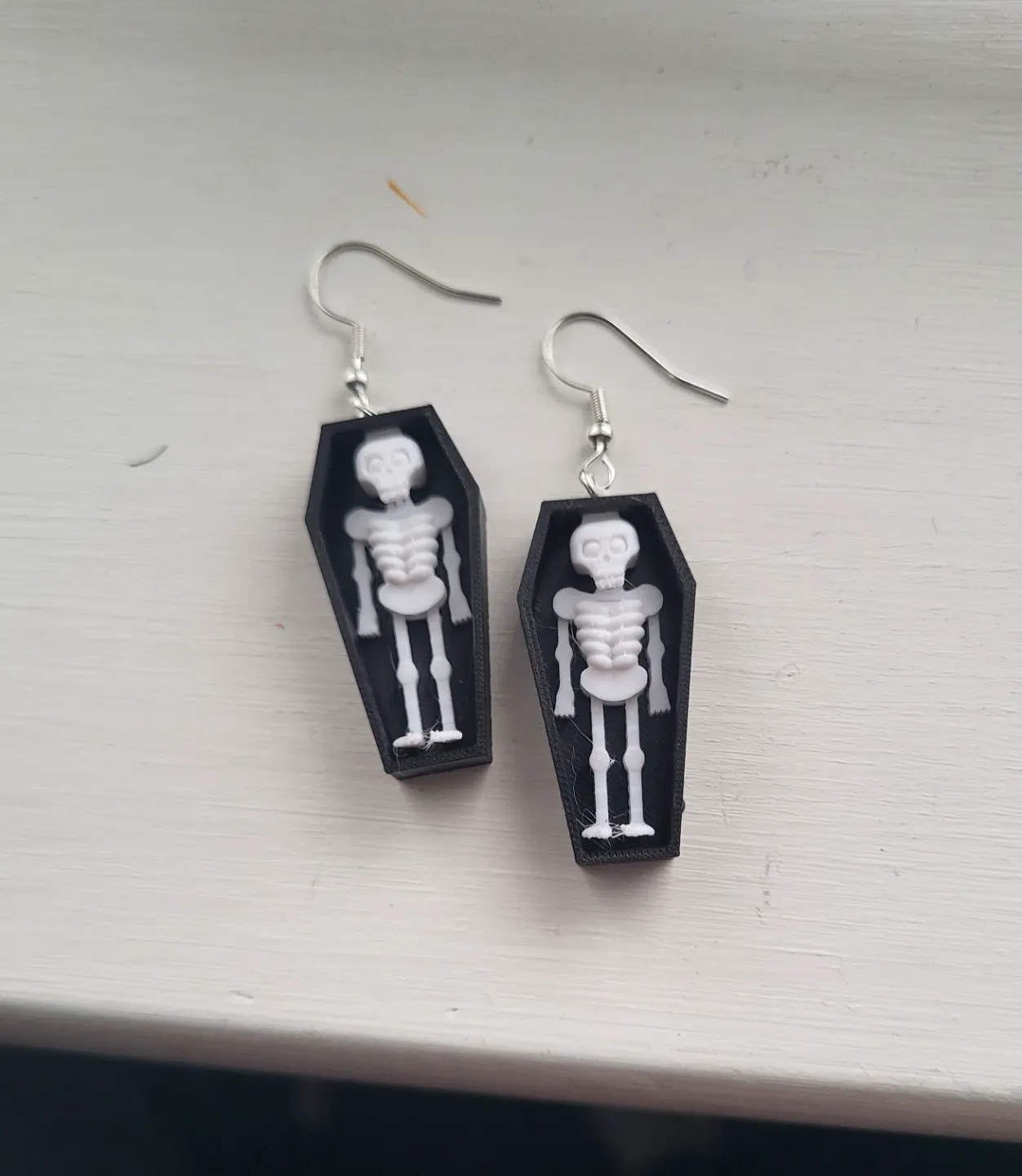 skeleton in coffin earring view 2
