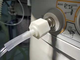 Anesthesia machine adapter for fresh gas outlet