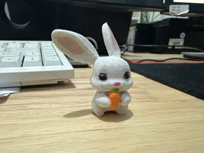 A very cute little white rabbit designed by BD4XBW eating a carrot