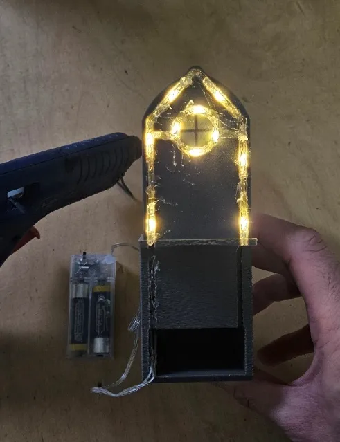 An image containing tools, person, indoors, holding. Automatically generated description