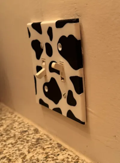 Switch cover plate, dual toggle, cow pattern