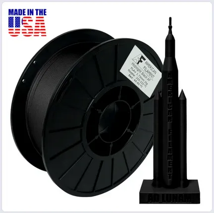 A spool of wire with a black object
Description automatically generated