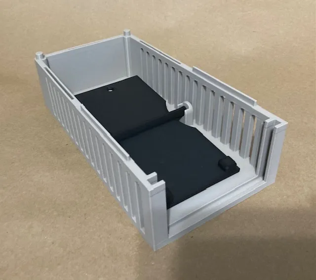 A white box with a black object inside
Description automatically generated