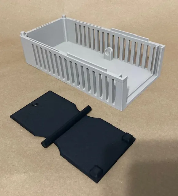 A white plastic container with a black cover

Description automatically generated