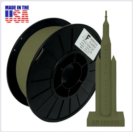 A spool of green wire with a black base
Description automatically generated