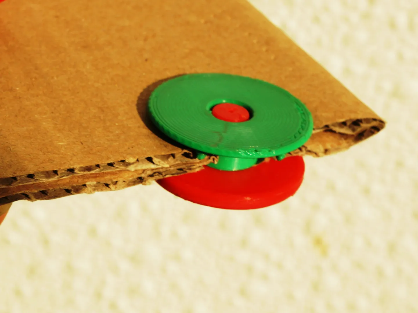 2 parts screwed together on cardboard 