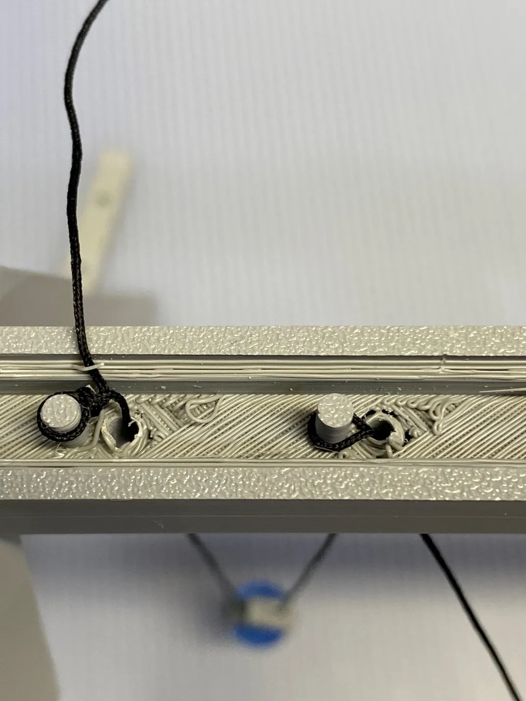 A close-up of a metal frame
Description automatically generated