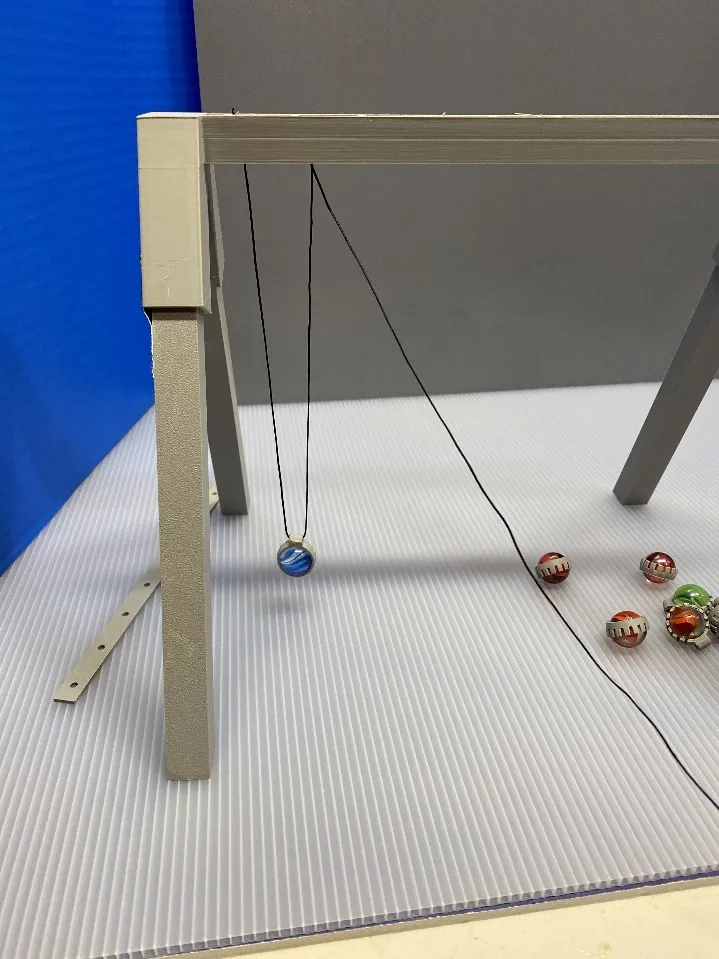 A ball on a string
Description automatically generated with medium confidence