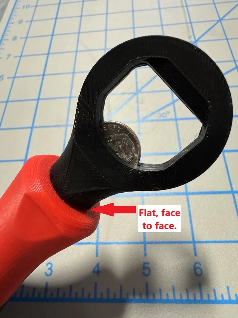A coin in a screwdriver
Description automatically generated