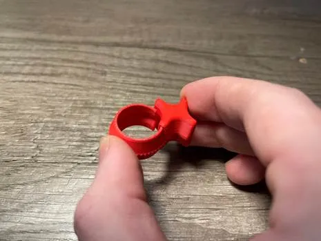 A hand holding a red ring

AI-generated content may be incorrect.
