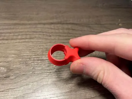 A hand holding a red object

AI-generated content may be incorrect.