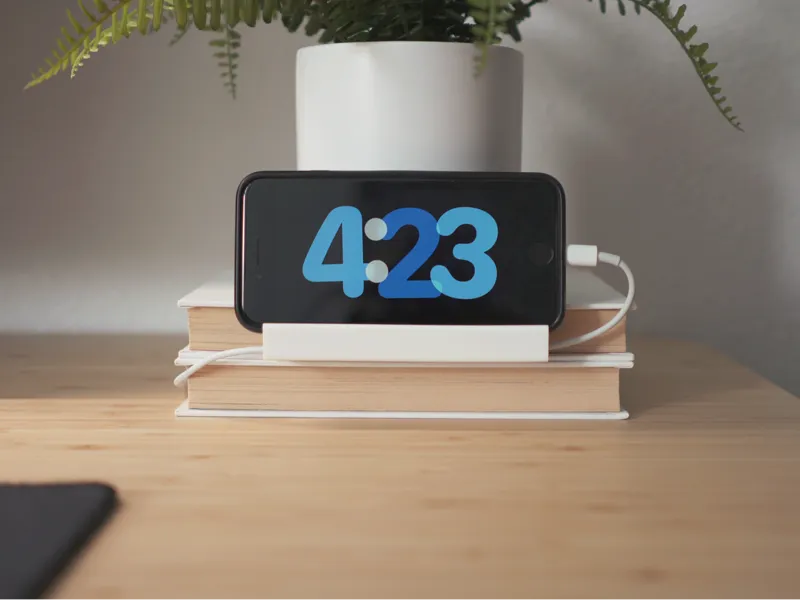Desk phone dock for stack of books.