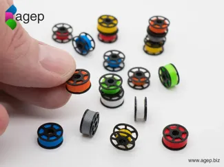 3D printed miniature filament spools.