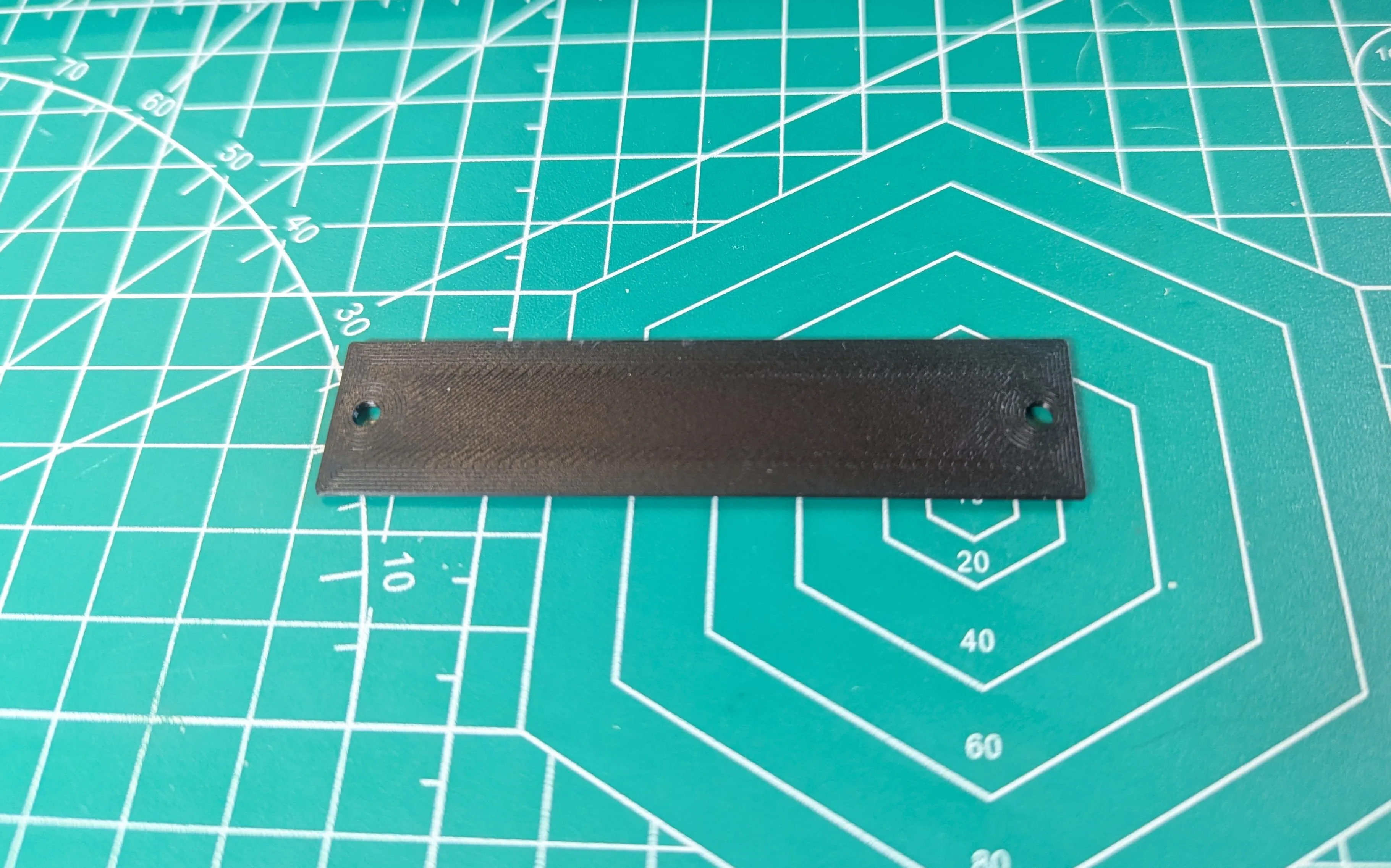 Photograph of single plate printed in black PLA