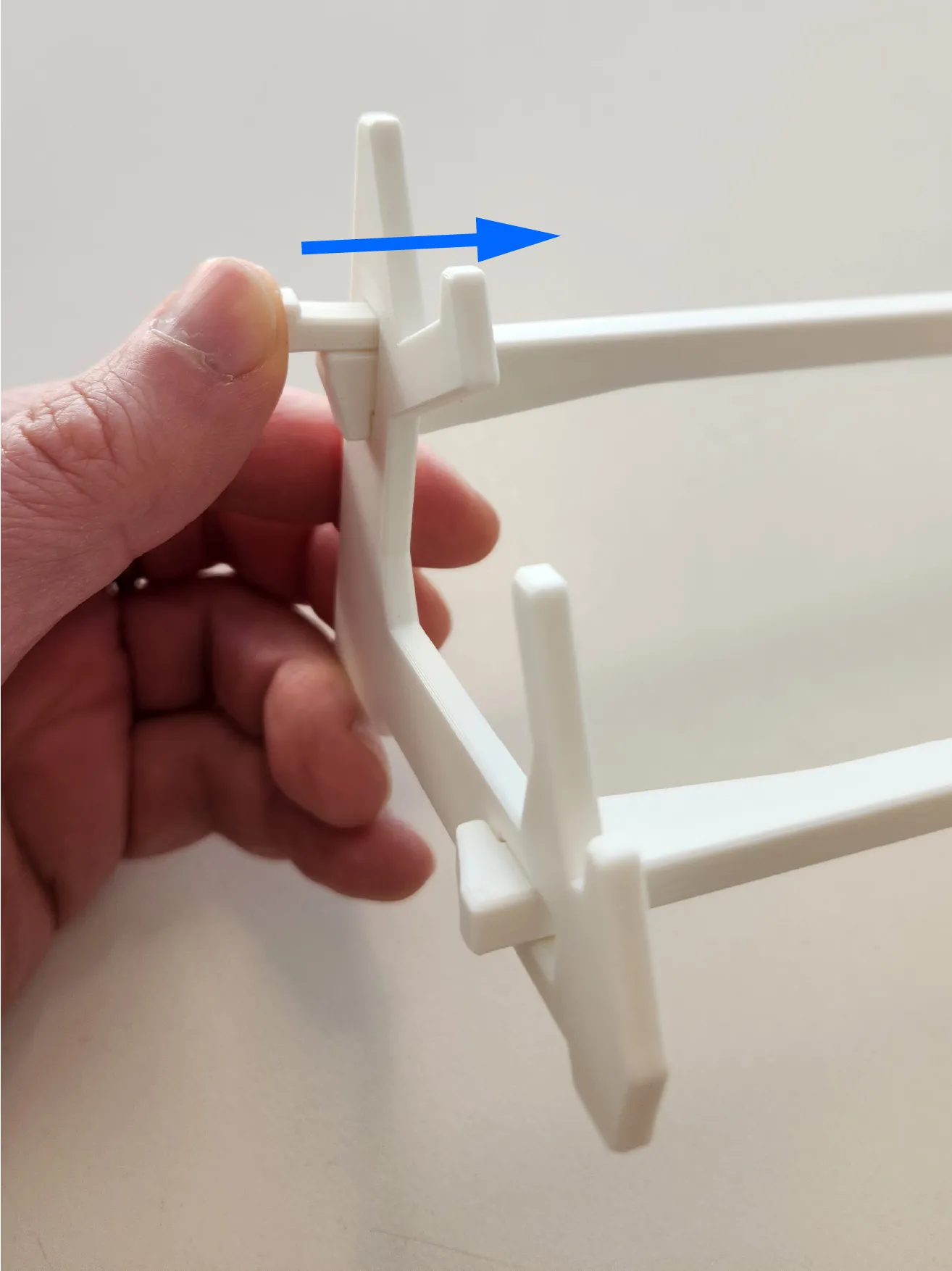 A thumb pushing the wedge into the side