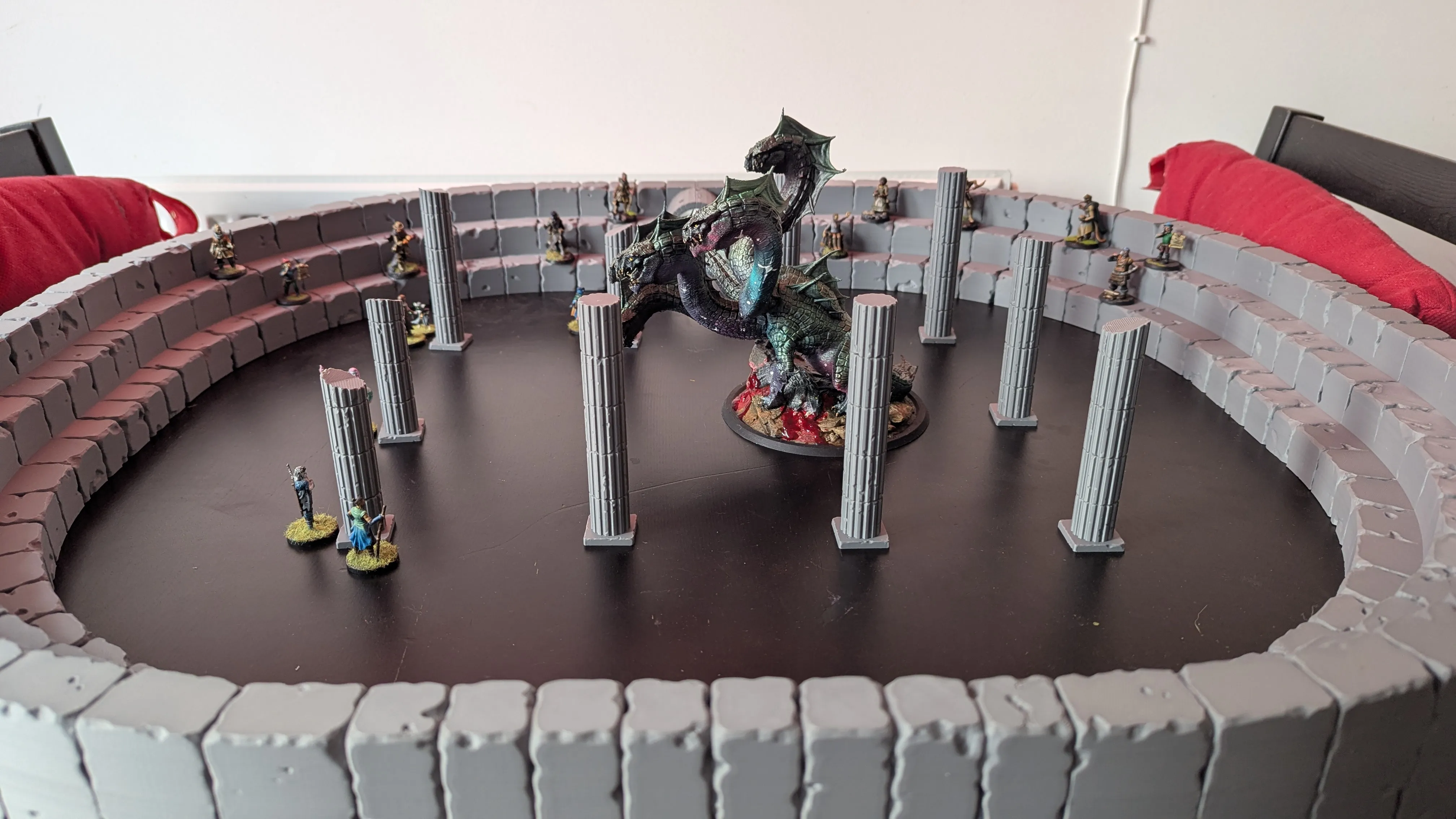 Nein mighty heroes battle a nyxborn hydra in the arena of Odunos as the crowd brays for blood