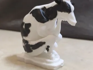 Cow making concentrated milk sculpture