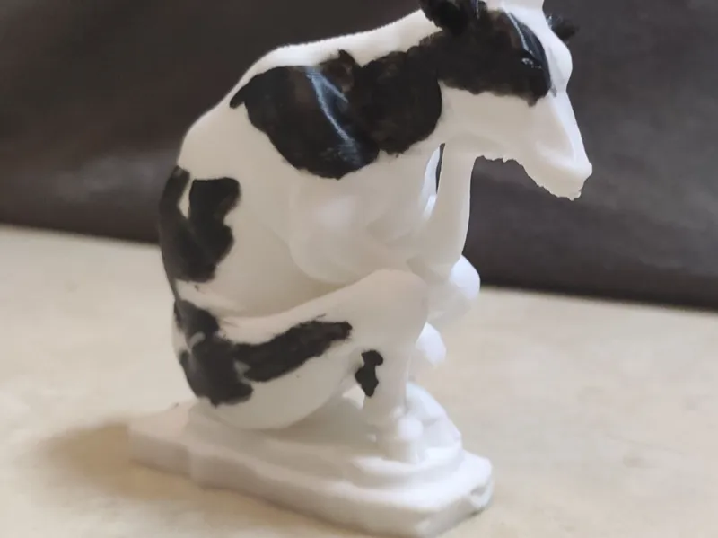 Cow making concentrated milk sculpture