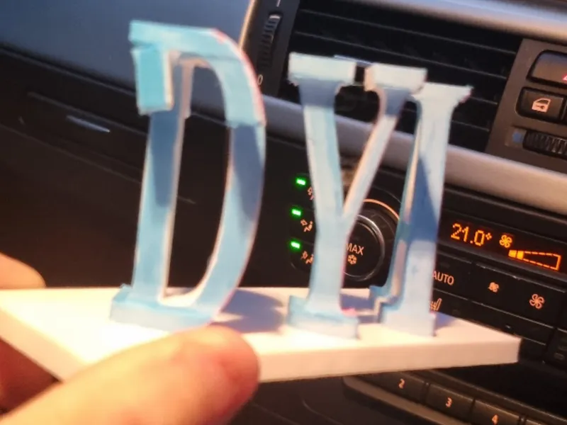 dyl and tia 3d text ilusion on a stand