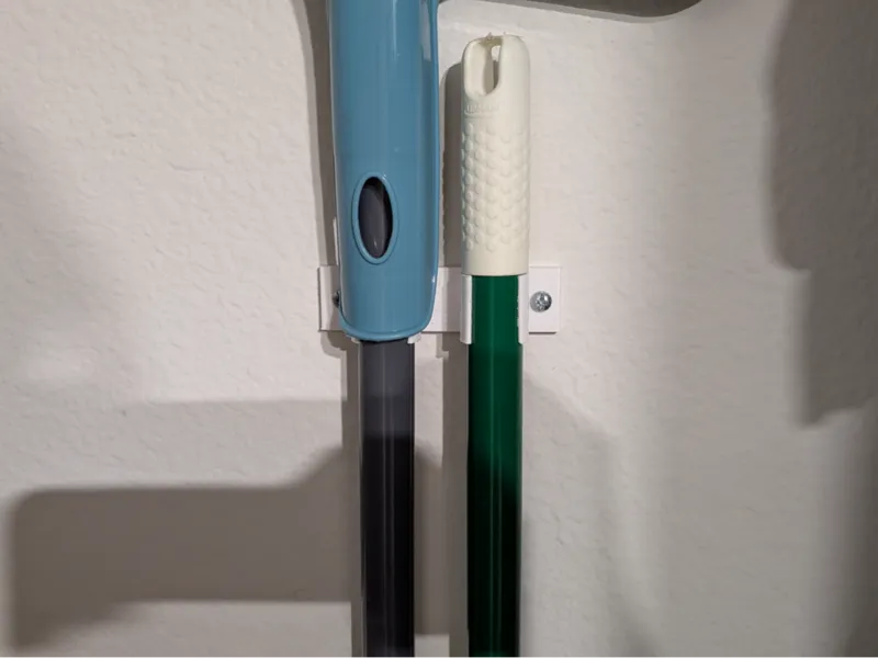 Wall holder for mops, brooms.