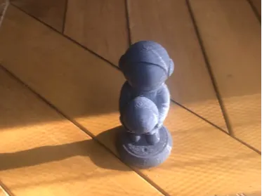 figure of an astronaut holding a moon