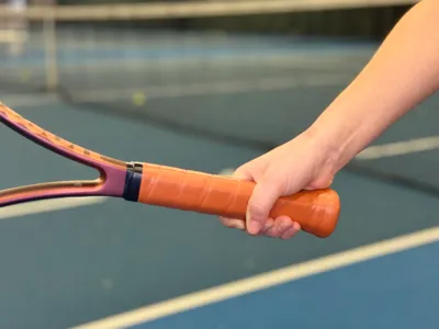 Tennis racket grip extender
