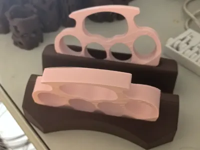 Ergonomically designed for hand grip, with a base for pink knuckle dusters