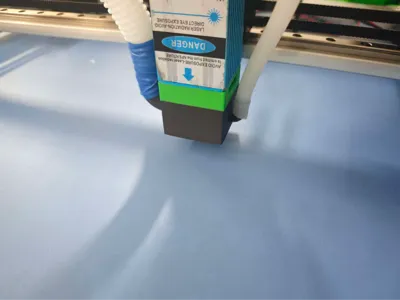 Laser engraving head blow and vacuum integrated air nozzle