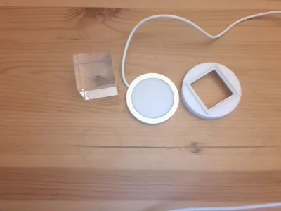 holder that holds a 3.8cm cube onto 6 by 6 cm lamp