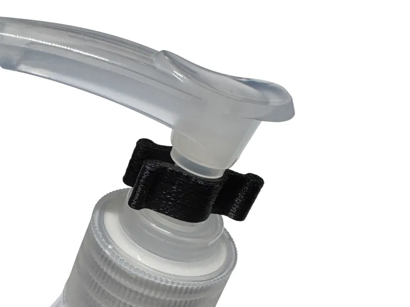 Travel pump bottle safety clip