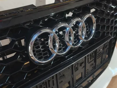 Audi logo holder front grill attachment