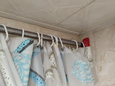 Shower curtain rod holder